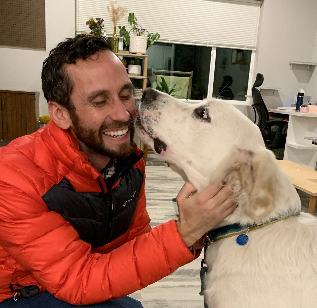 Dr. Jake Rodgers with his dog Percy giving him a kiss — Vet Buddies founder, Northern Colorado